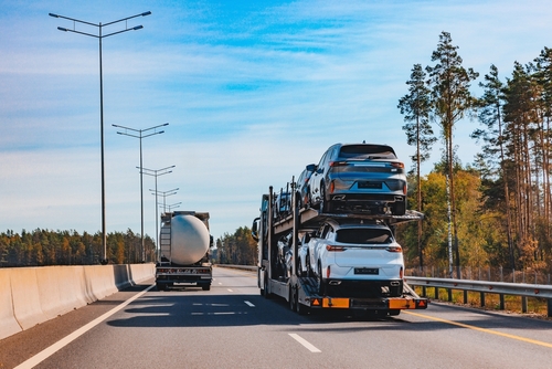 Open car shipping truck delivering vehicles safely