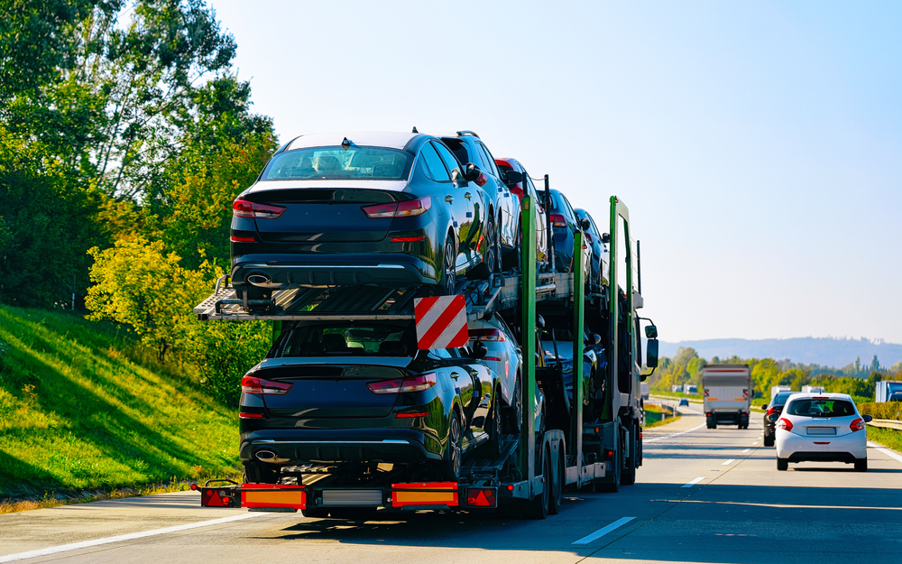 Professional car transport service in Dallas TX loading a vehicle onto an auto transport carrier